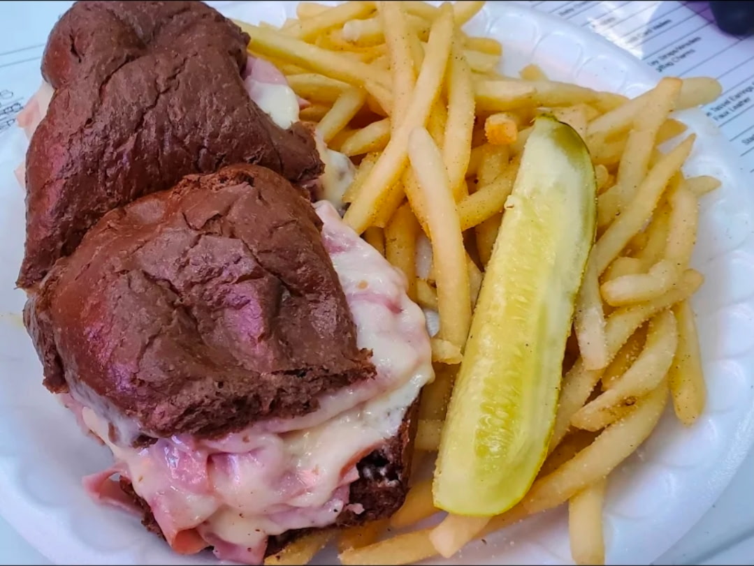 Steamed deli sandwich stacked with corned beef and pickles