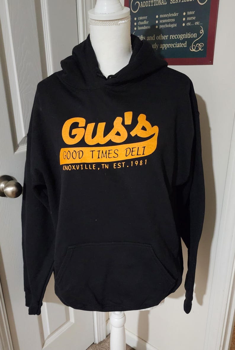 Black Gus's Good Times Deli hoodie - front with orange logo