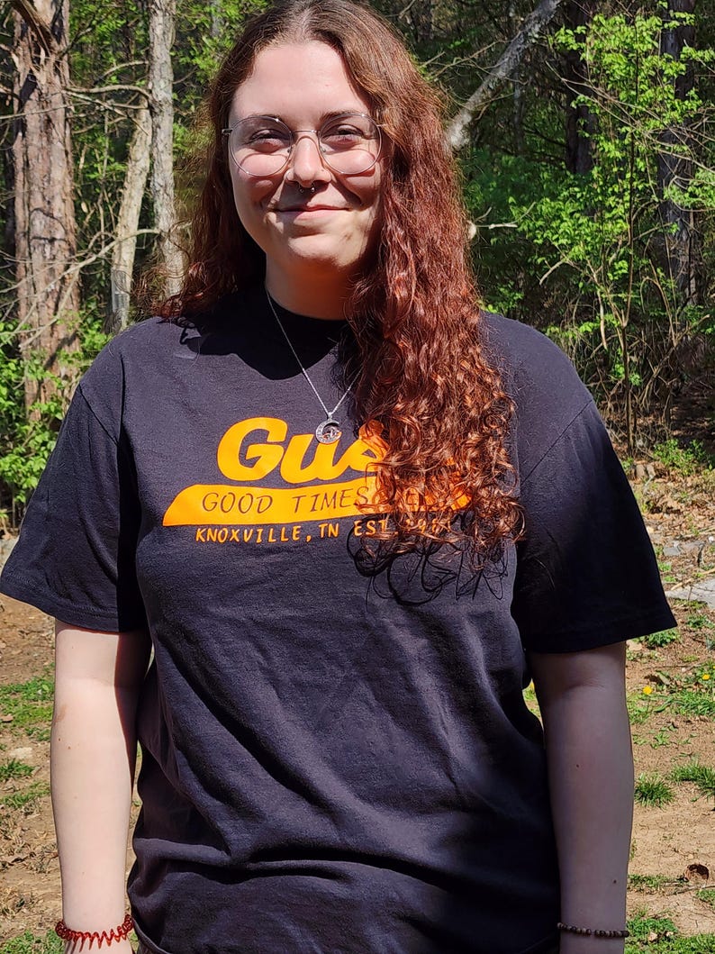 Dark Gus's Good Times Deli t-shirt - front with orange logo